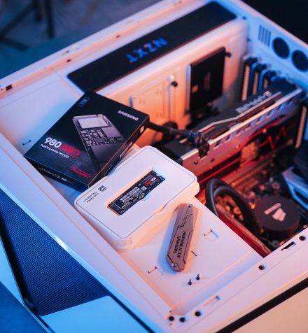 Disque NVMe et sa boîte, posés dans un boîtier avant montage